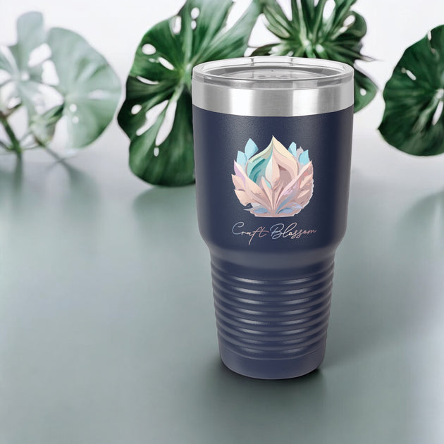 a stainless steel tumbler cup with a leaf design