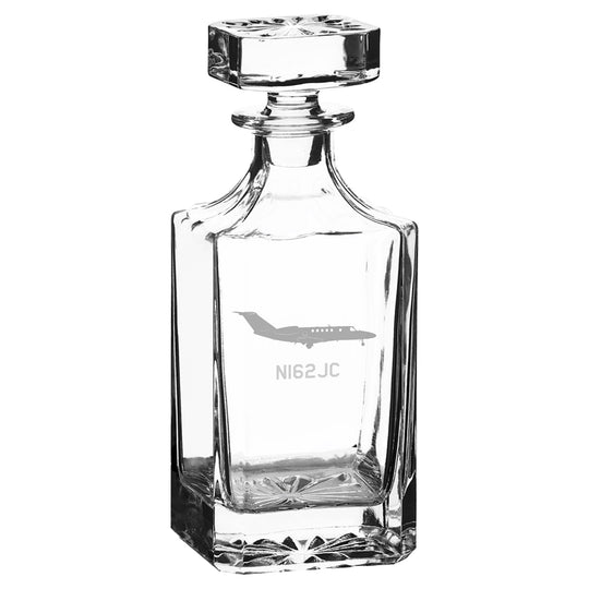 a glass bottle with a plane on it