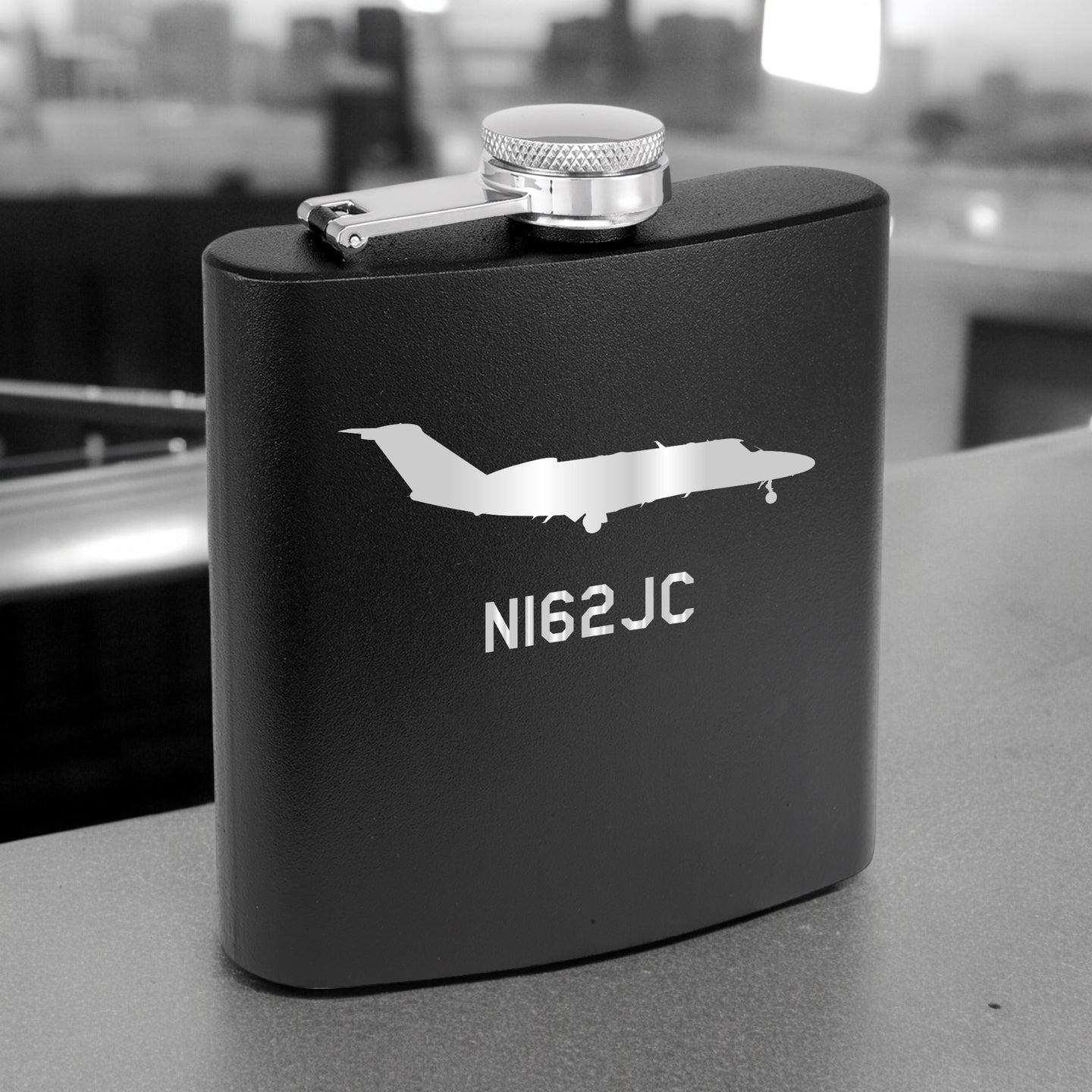 a black flask with a jet on it