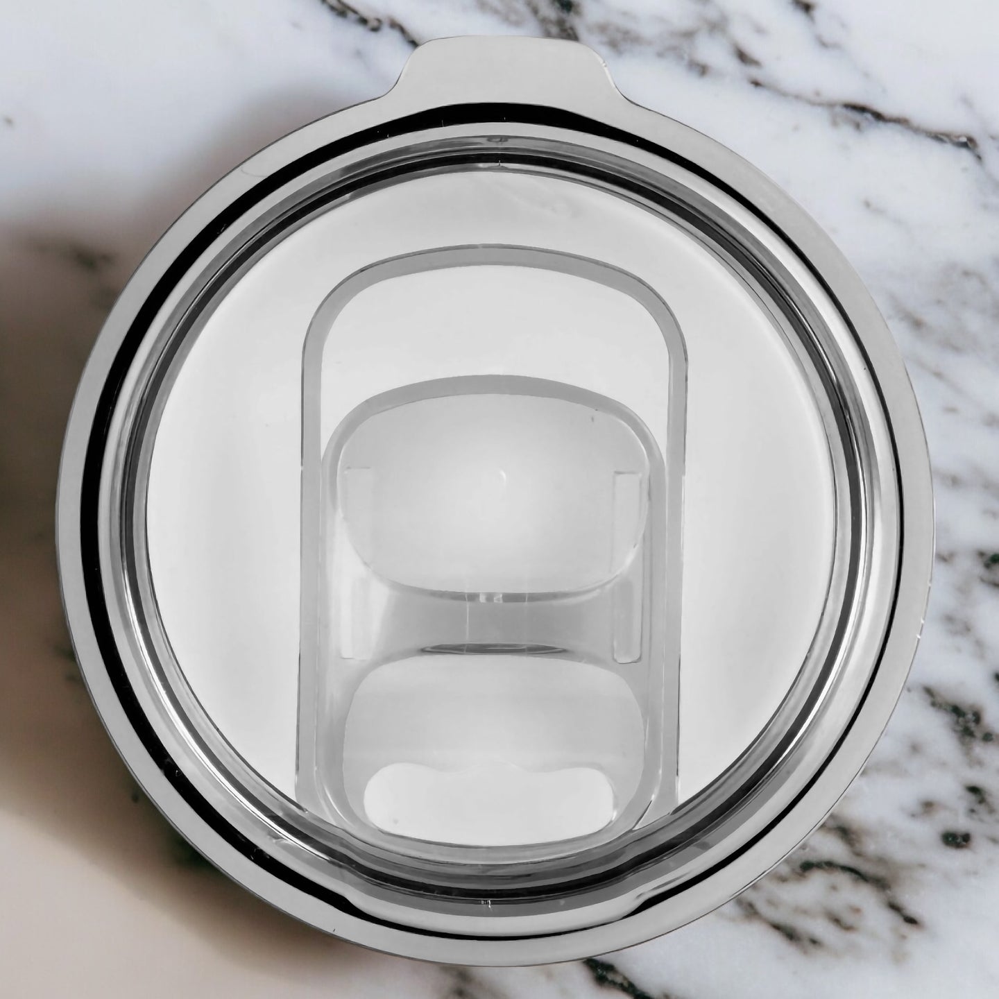 an overhead view of a glass cup on a marble surface