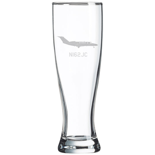 a tall glass with a plane etched on it