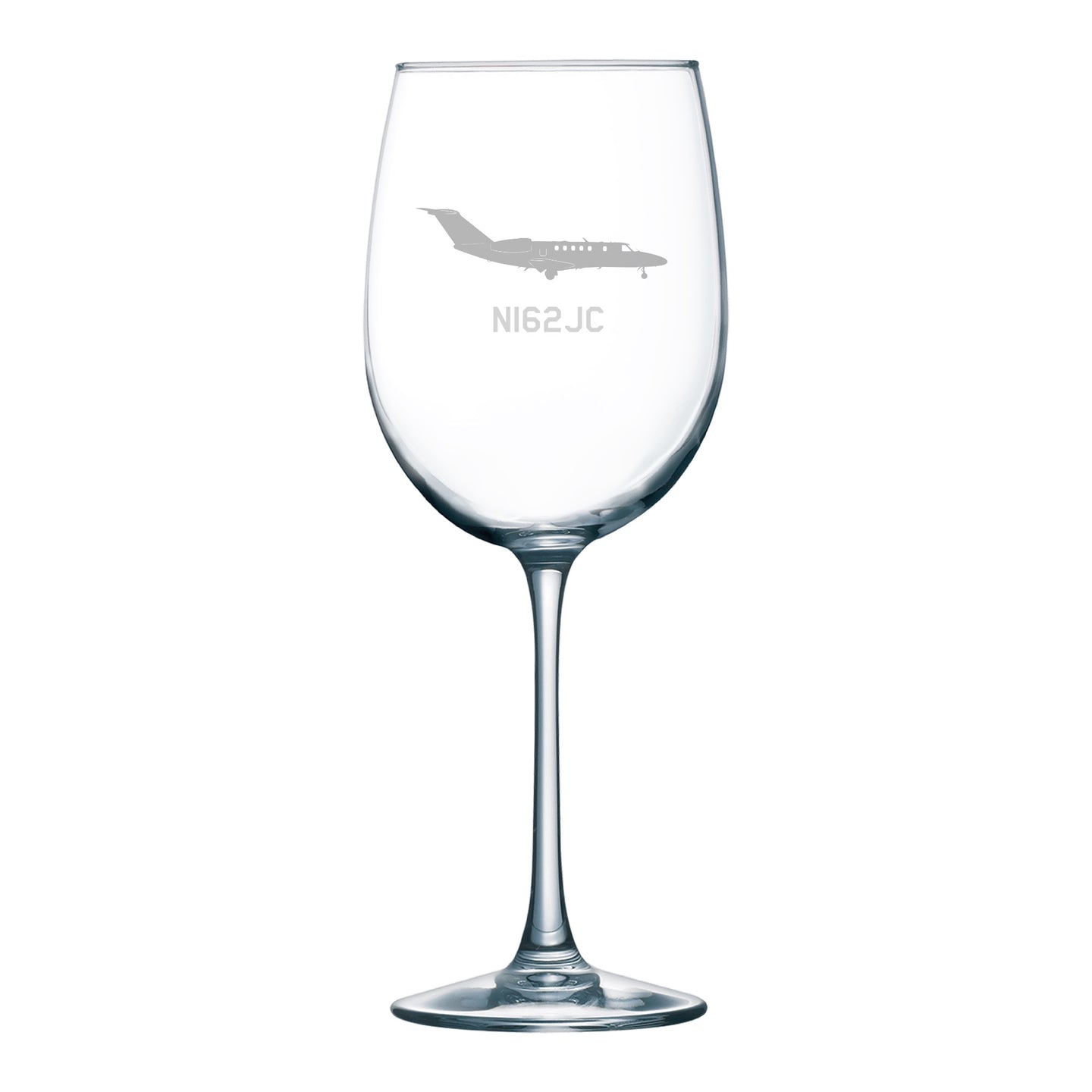 a wine glass with an airplane etched on it